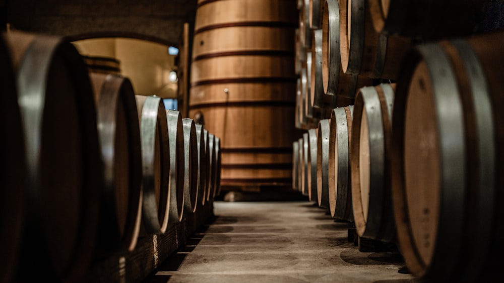 a row of wine barrels in a wine cellar