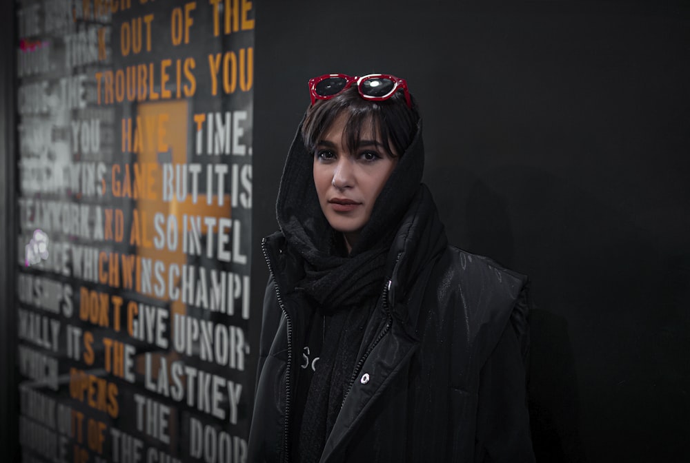 a woman wearing sunglasses and a black jacket