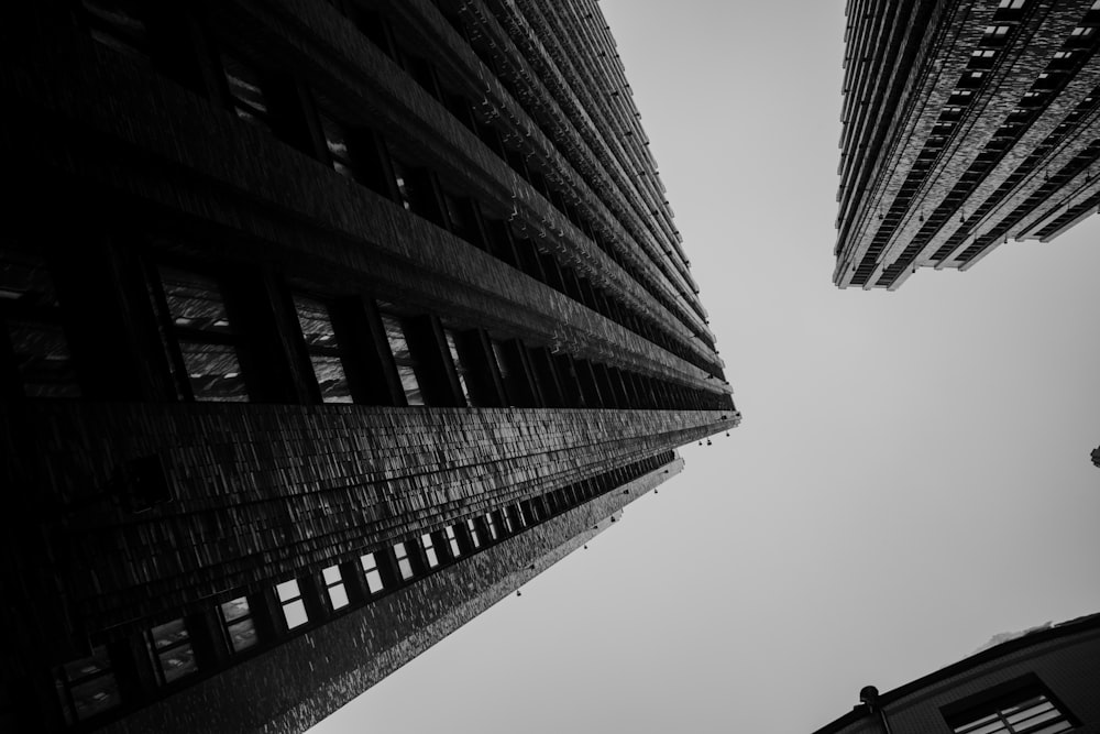 a black and white photo of two tall buildings