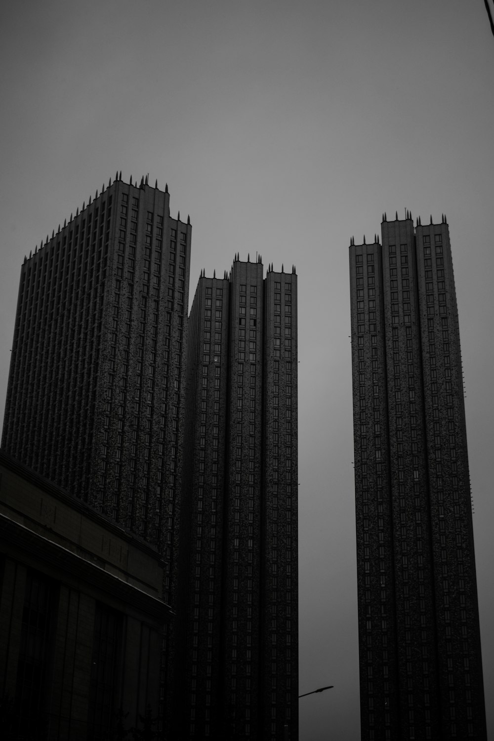 a black and white photo of two tall buildings