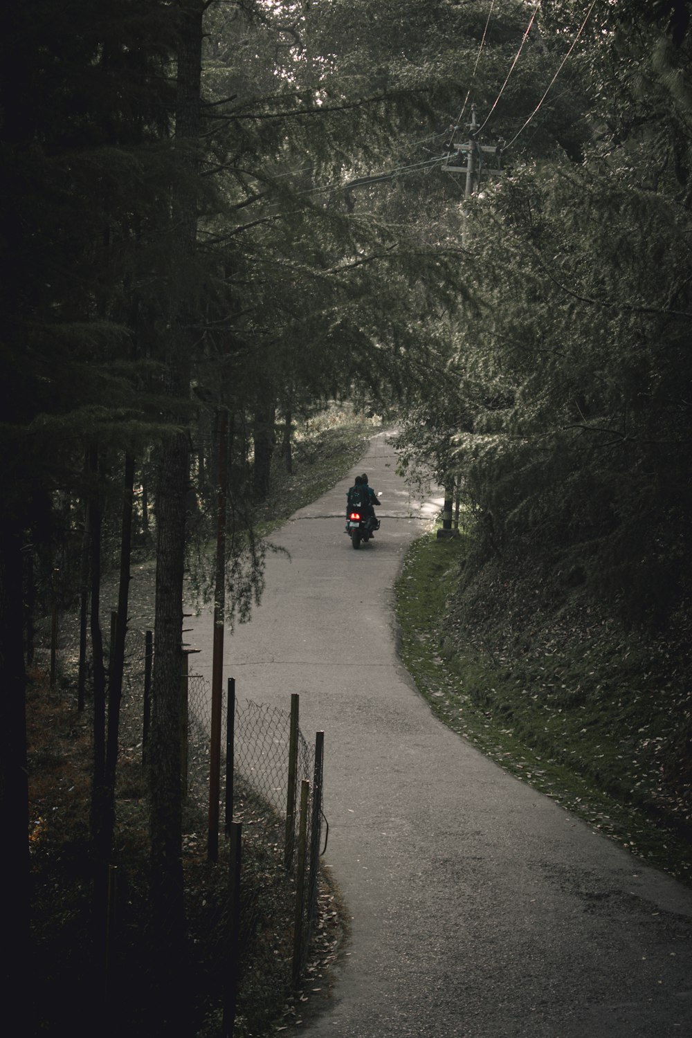 a person riding a motorcycle down a road