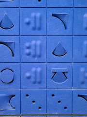 Minimalist puzzle with bright cyan blocks fitting together.