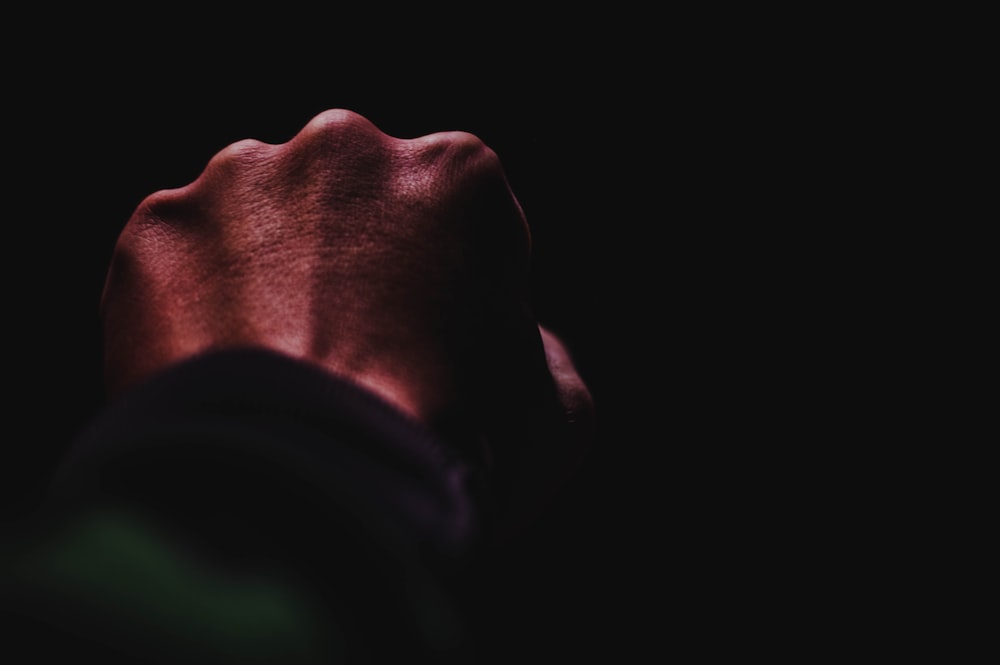 a person's hand in the dark