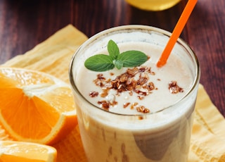 Orange milk shake with granola and mint