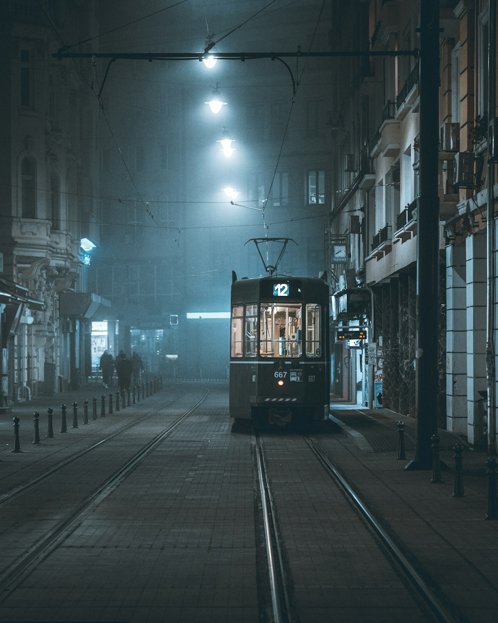 a trolley car on a city street at night