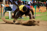 Mascot jumping over the Long Jump logo with a trail of light.