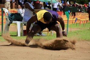Energetic athletes jumping mid-air with vibrant Long Jump cans in hand.
