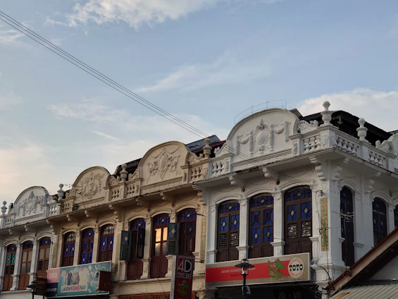 Historic colonial buildings in Puebla bathed in warm sunlight, showcasing intricate details and vibrant colors.