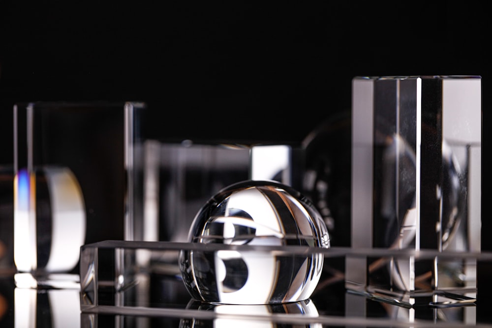 a black and white photo of a group of glass objects