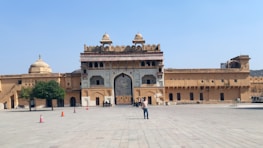 Happy travelers enjoying a group tour at a historic fort in India arranged by Royal Ride.