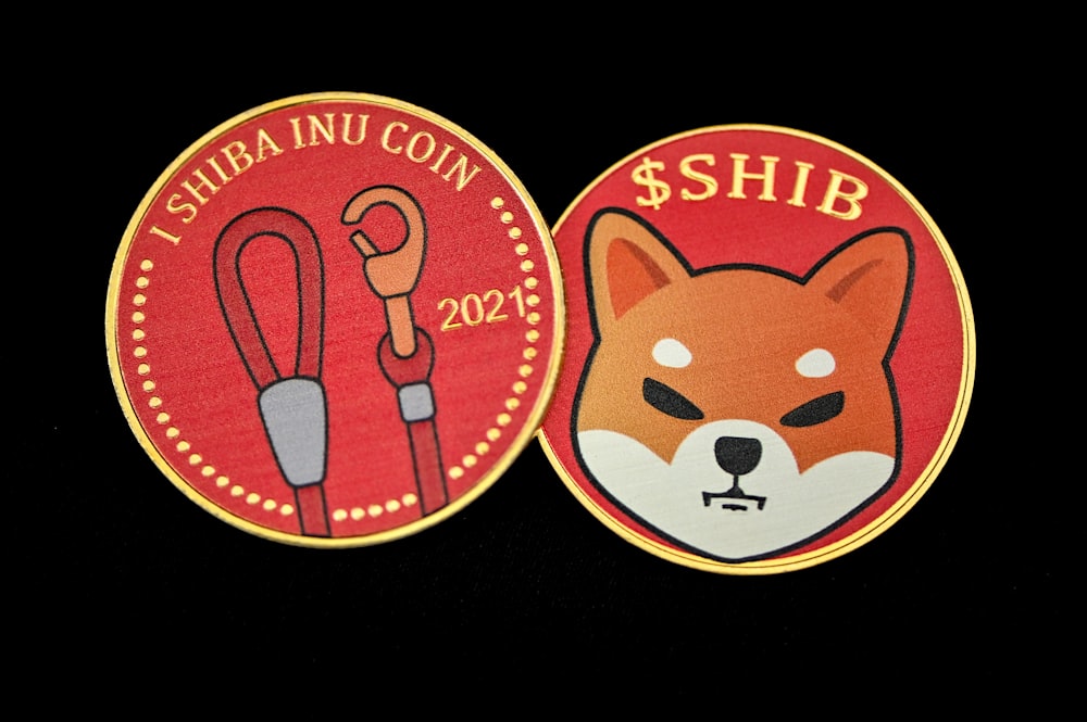 a close up of two badges on a black background