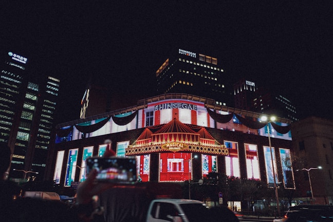 Night view of 강남썸데이 쩜오 building illuminated with vibrant city lights