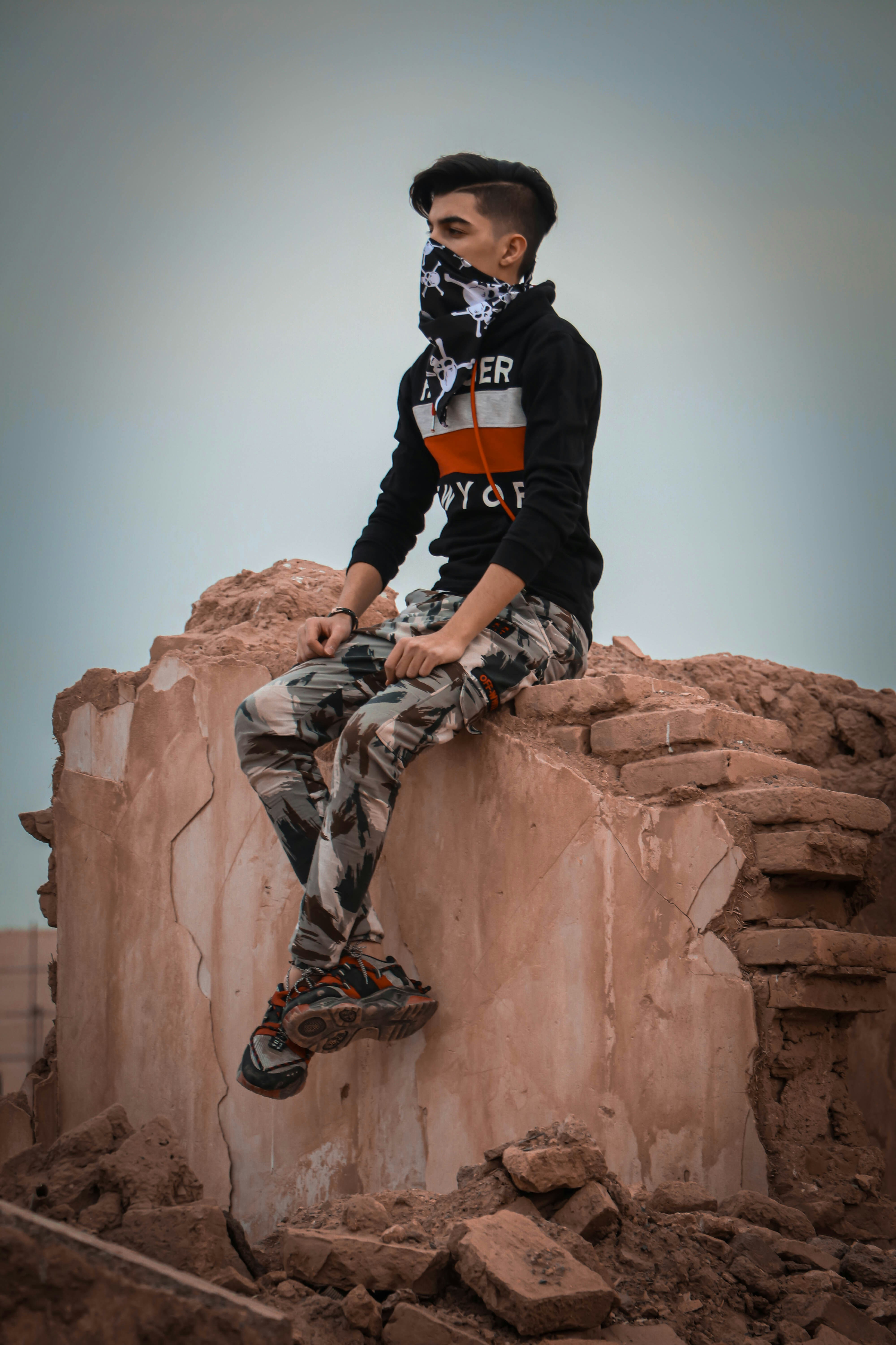 a man sitting on top of a rock formation