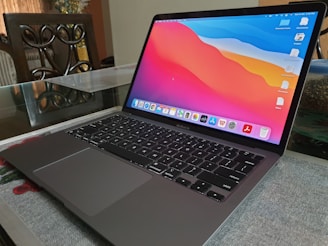 A sleek laptop with a vibrant screen displaying a tech review article on infobolt.