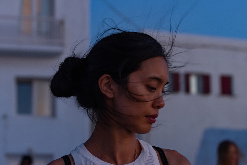 a woman with her hair blowing in the wind