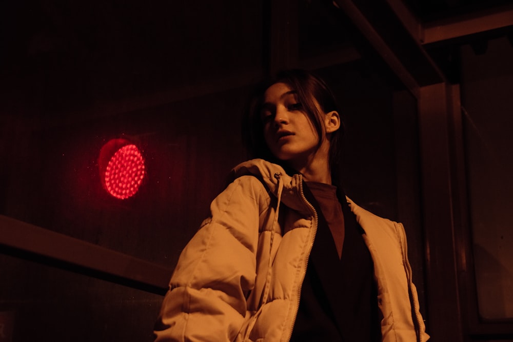 a woman standing in front of a stop light