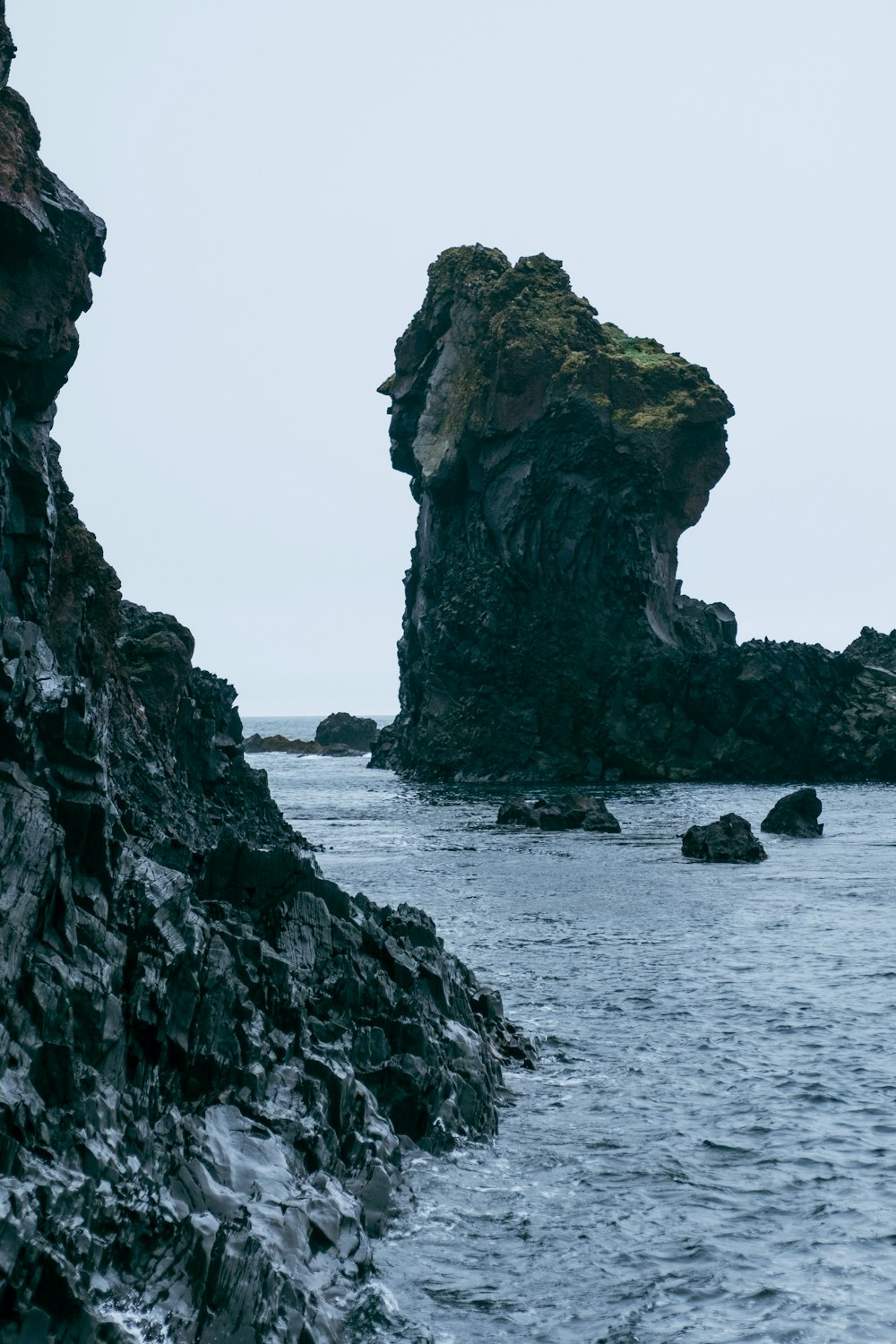 a rock outcropping in the middle of a body of water