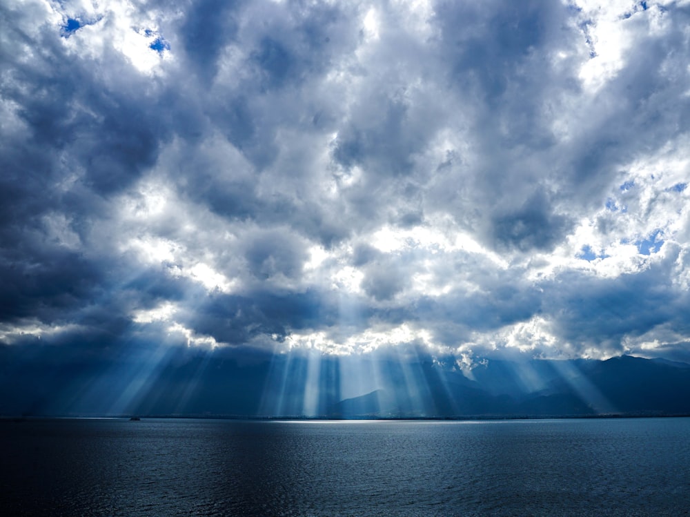 a large body of water under a cloudy sky