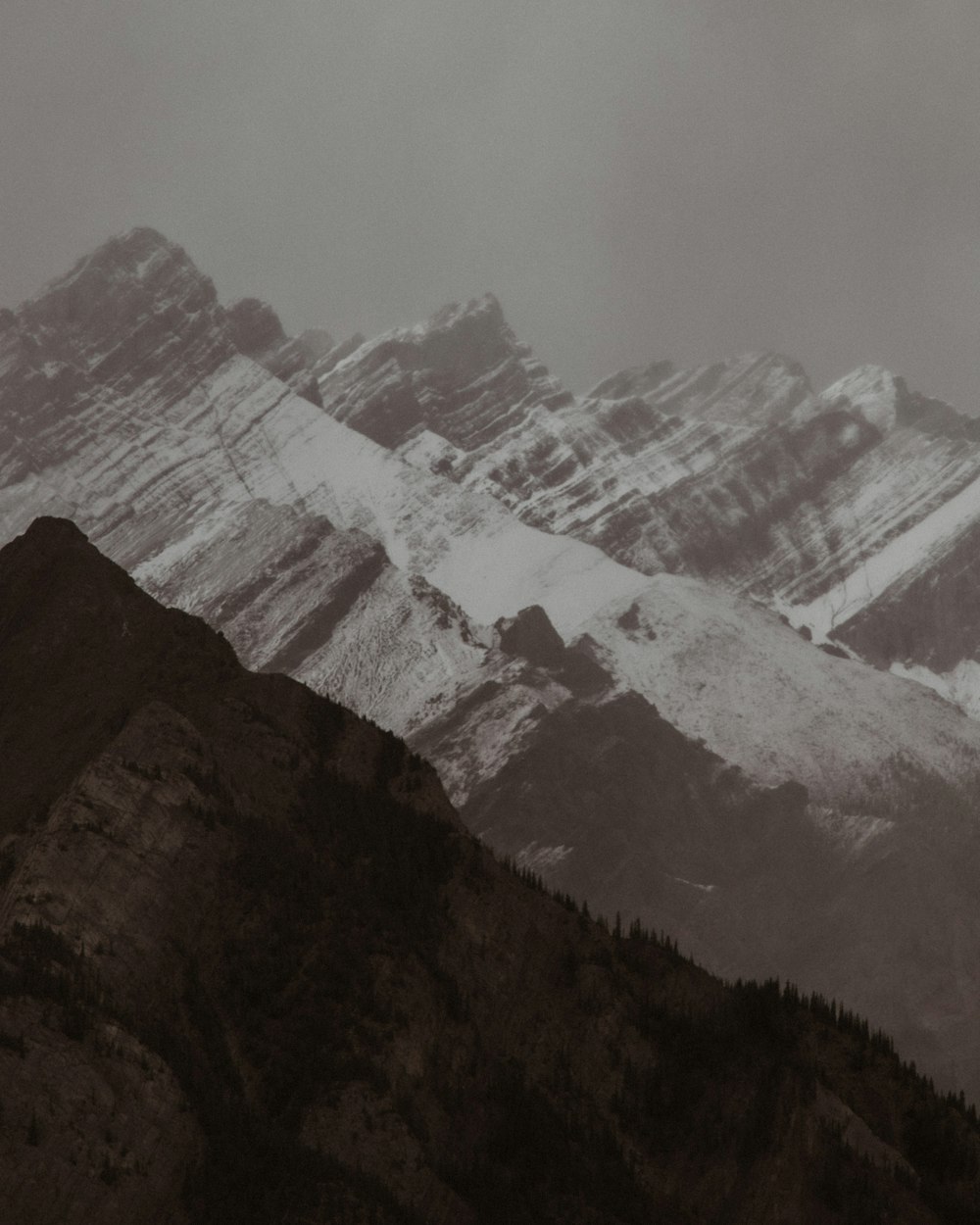 a black and white photo of a mountain range