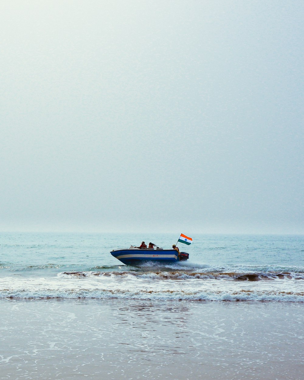 a small boat with two people on it in the ocean