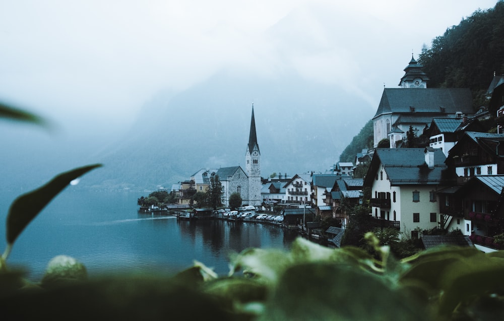 a view of a town on a lake with mountains in the background