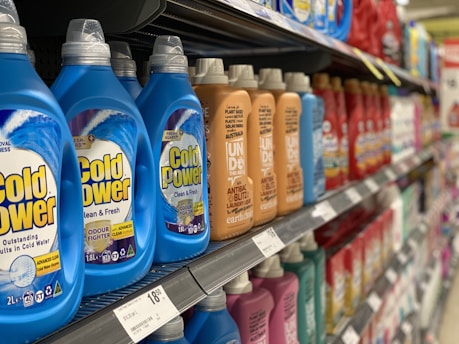 bottles of cold power on a shelf in a store