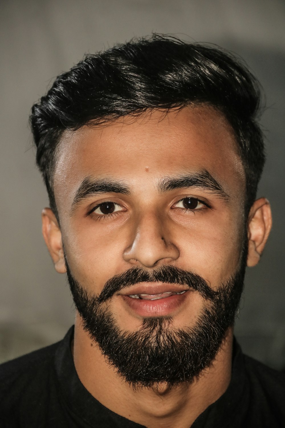 a man with a beard and a black shirt