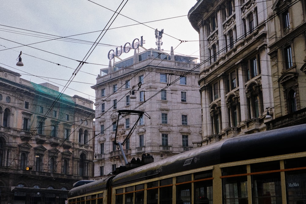 a train traveling down a street next to tall buildings