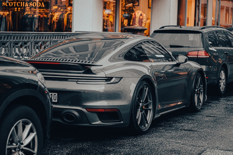 a couple of cars parked next to each other on a street