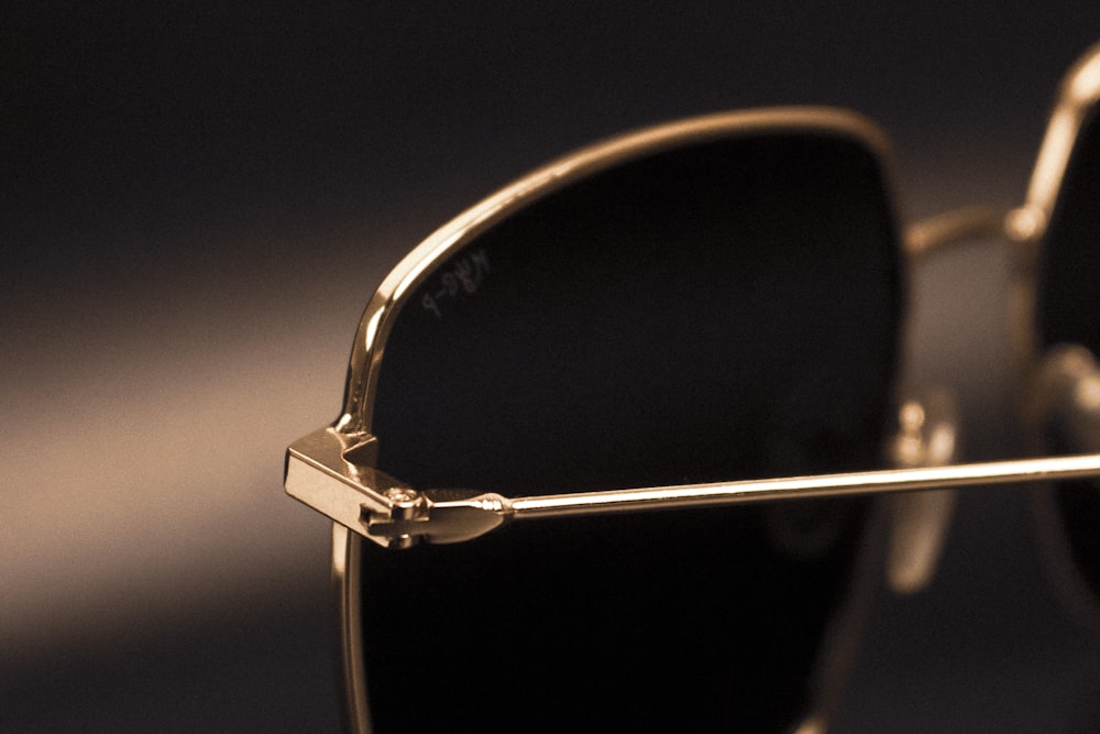 a pair of gold sunglasses with black lenses