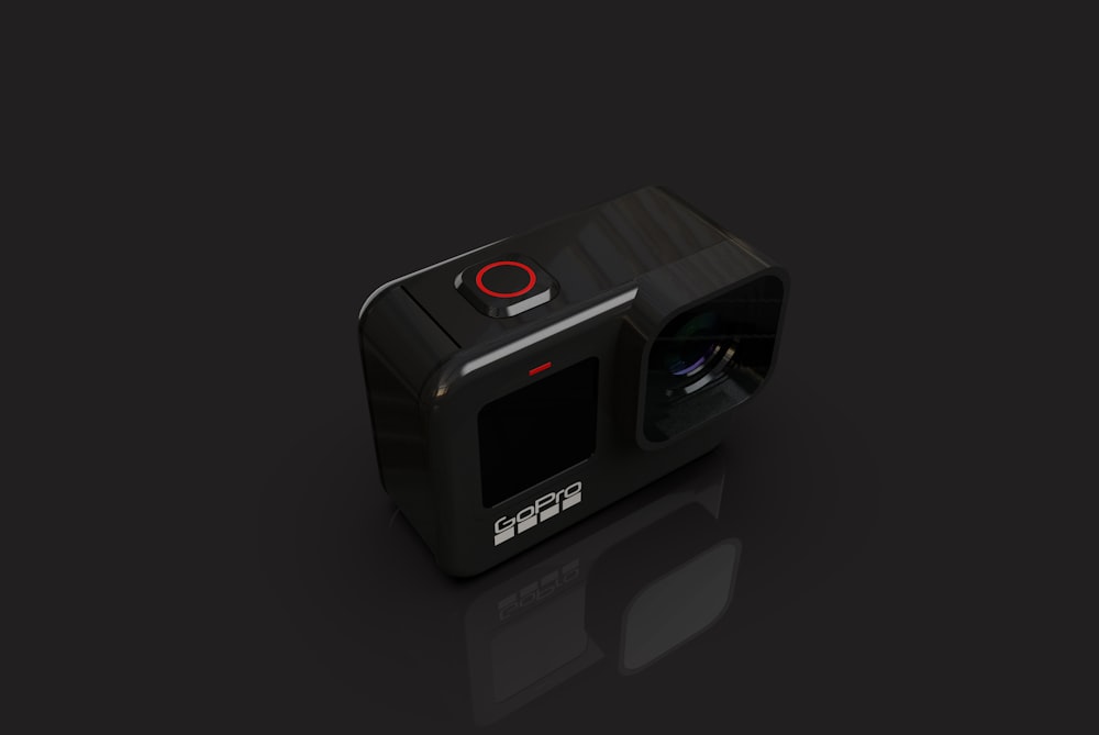 a black camera with a red lens on a black background