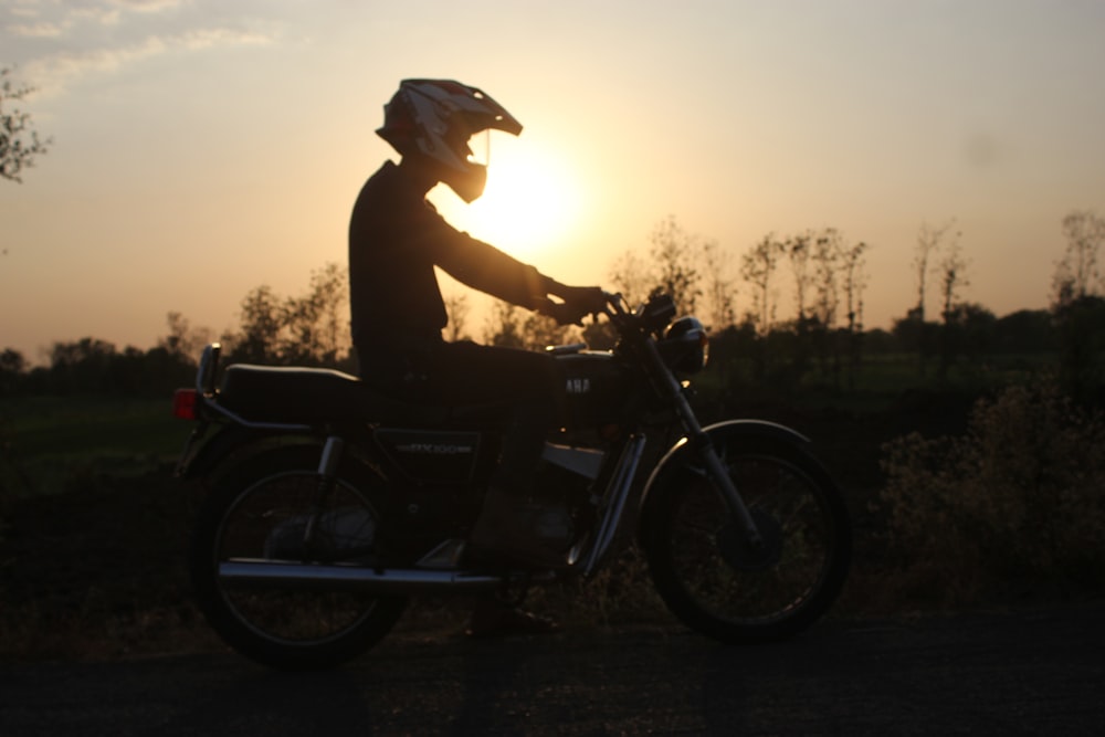 a person riding a motorcycle on a rural road