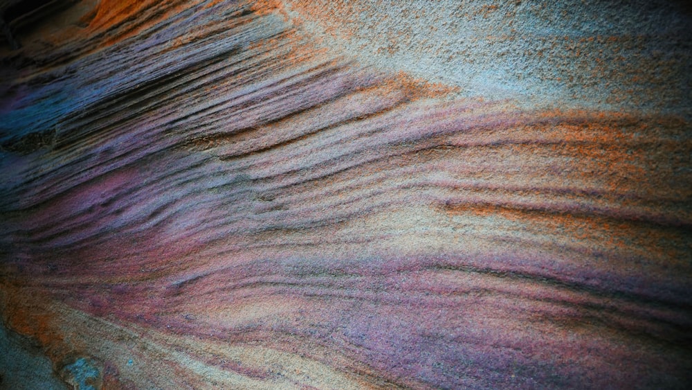 a close up of a sand dune with a blue sky in the background