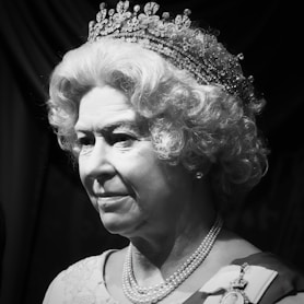 a black and white photo of a woman wearing a tiara