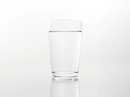 a glass of water on a reflective surface