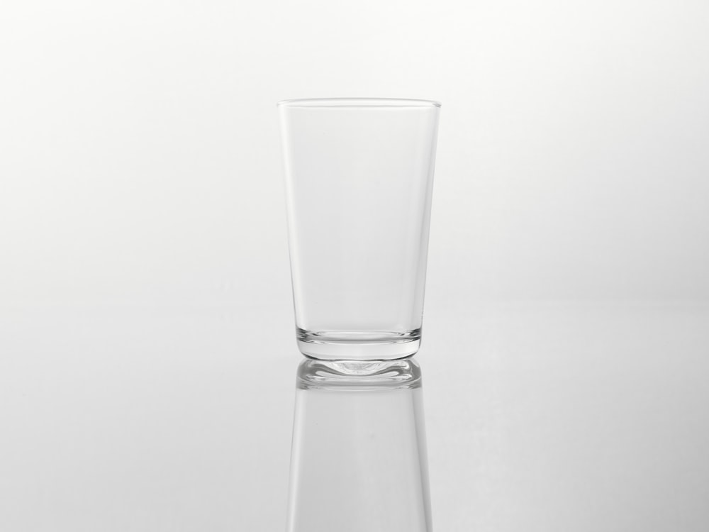 a tall glass sitting on top of a table