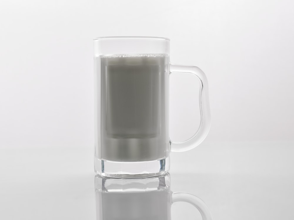 a glass of milk sitting on top of a table