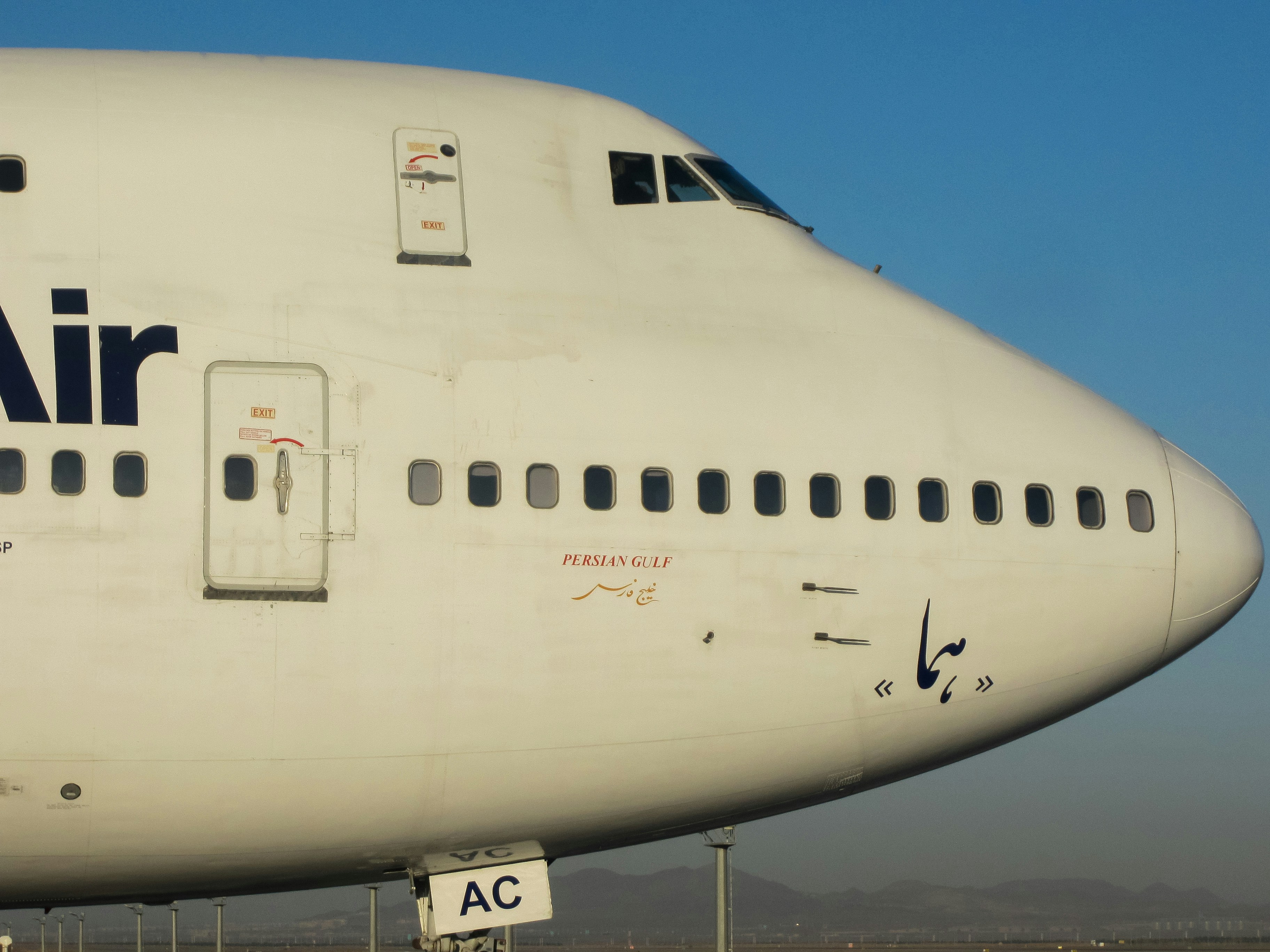 a large air plane sitting on top of an airport tarmac, lovely boeing 747 sp in imam khomeini international airport