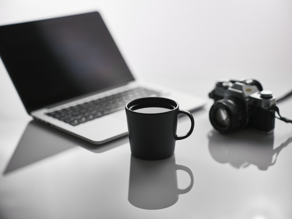 a laptop computer sitting on top of a white table