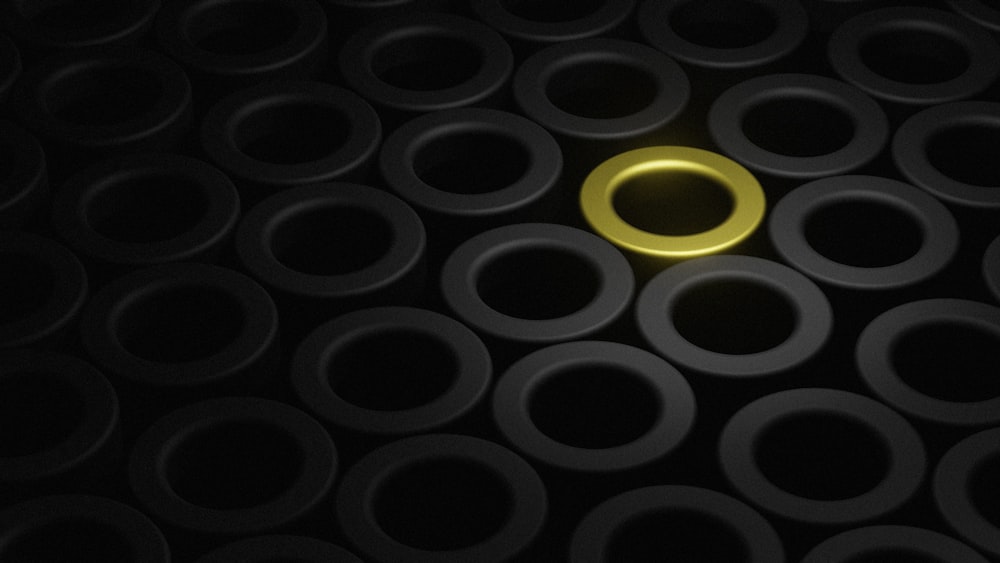 a circle of black circles with a gold ring in the middle