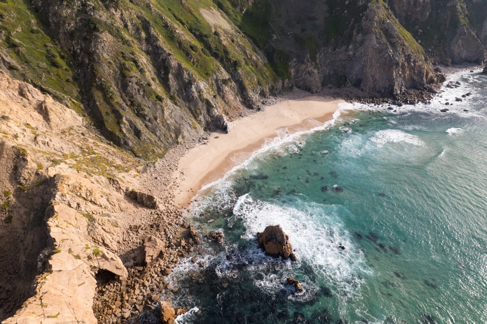 an aerial view of a beach and cliffs