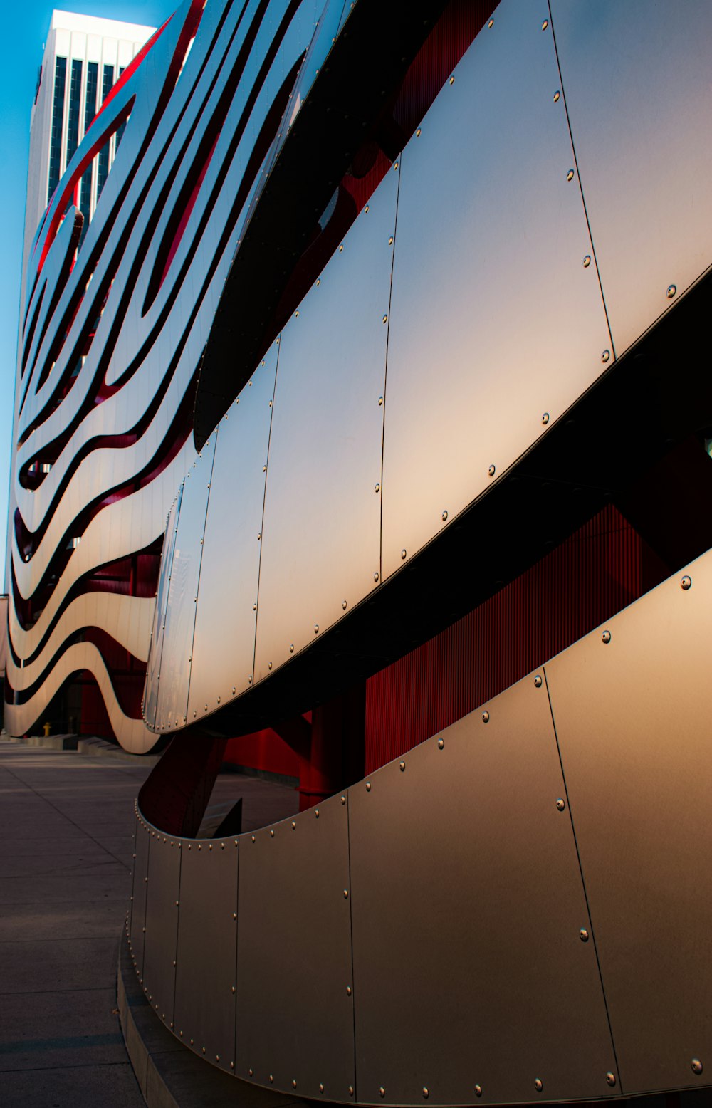 a modern building with a curved metal facade