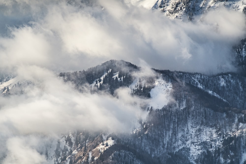 a view of a mountain covered in clouds