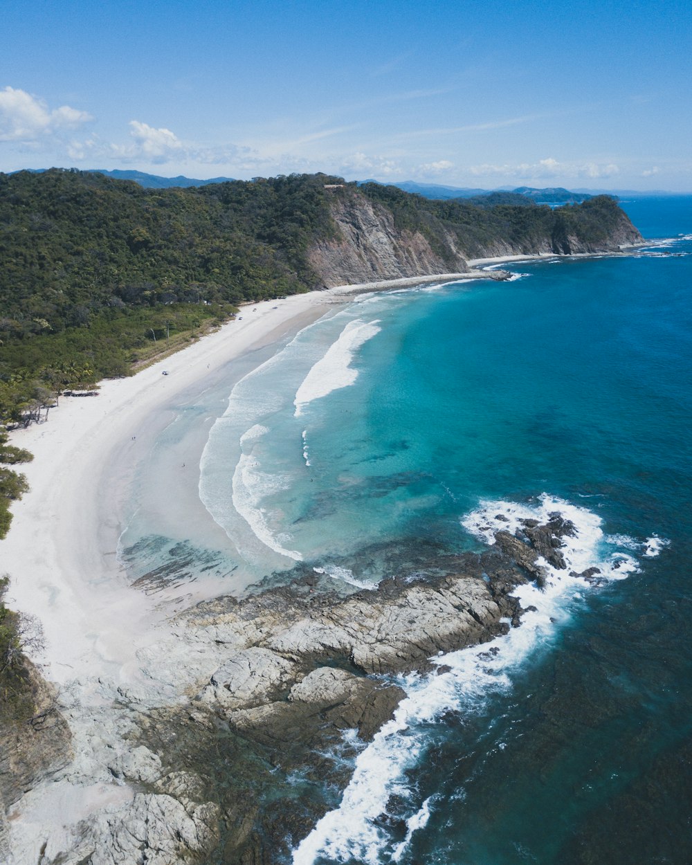 an aerial view of a sandy beach and ocean