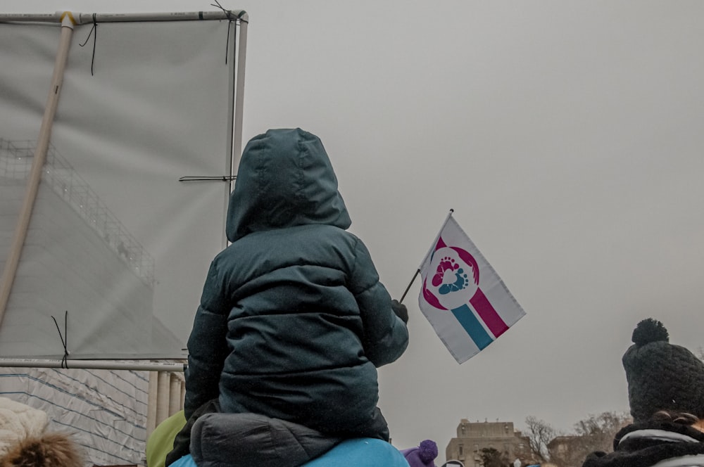 a small child is flying a kite in the air