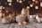 A collection of scented candle jars of various sizes and designs is arranged on a rustic wooden surface. The jars are labeled with the words 'Scented Candle Jar.' The background features a bokeh effect with warm, golden lights, creating a cozy atmosphere.