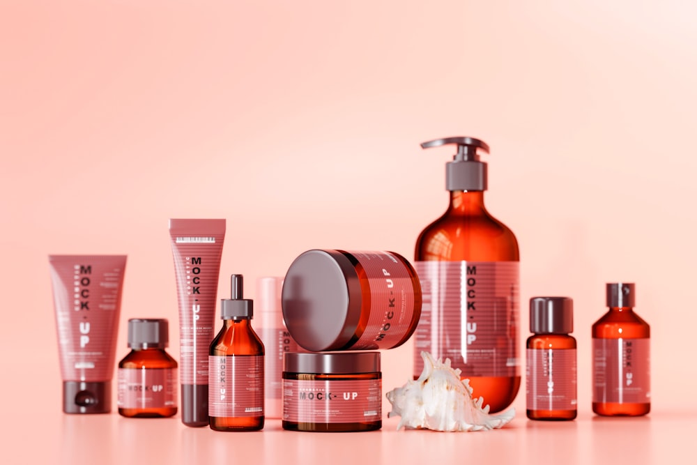 a collection of skin care products on a pink background