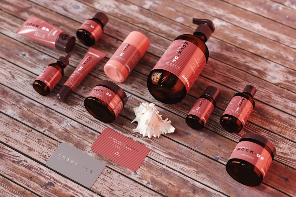 a wooden table topped with lots of bottles of lipstick