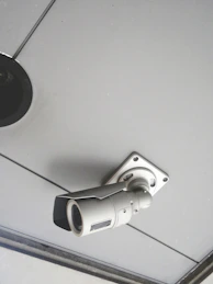 a security camera mounted to the ceiling of a building