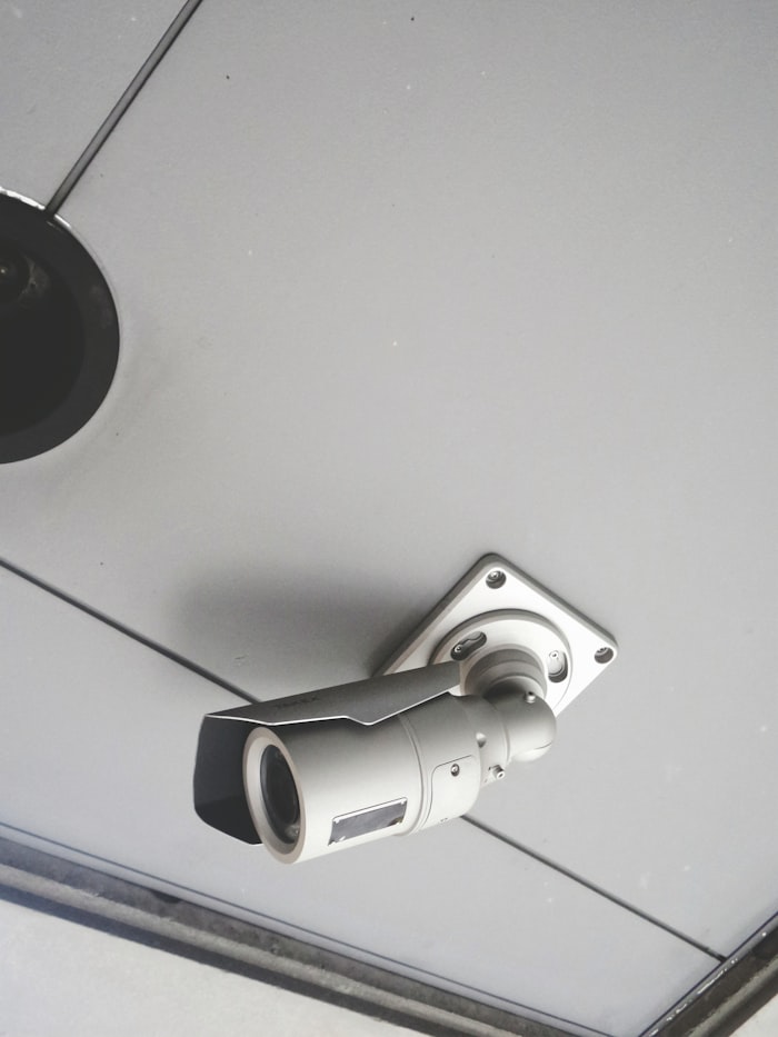 CCTV surveillance camera mounted on a building ceiling